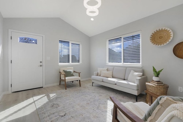 living room with vaulted ceiling and light wood-type flooring