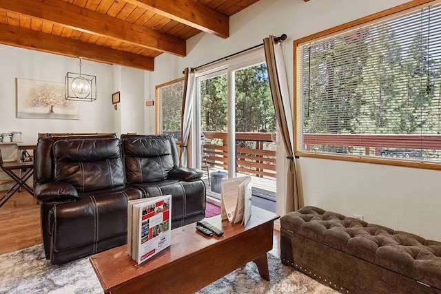 living room featuring hardwood / wood-style floors, wood ceiling, beamed ceiling, and an inviting chandelier