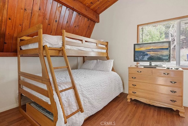 bedroom with wood-type flooring, vaulted ceiling with beams, and wooden ceiling