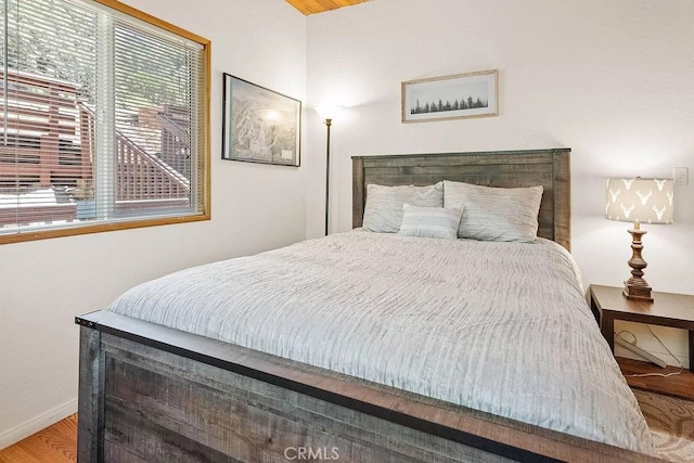 bedroom with hardwood / wood-style flooring