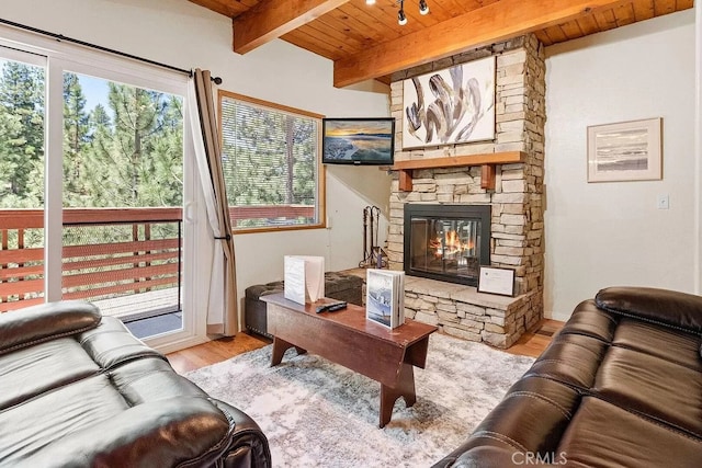 43869 Mendocino Dr, Big Bear Lake, CA 92315 - living room featuring wood ceiling with exposed beams, wood finished floors, and a stone fireplace