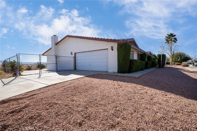 view of side of home featuring a garage