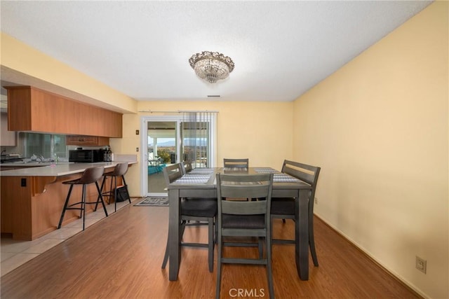 dining space featuring light hardwood / wood-style flooring