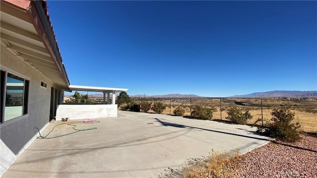 view of patio / terrace featuring a mountain view