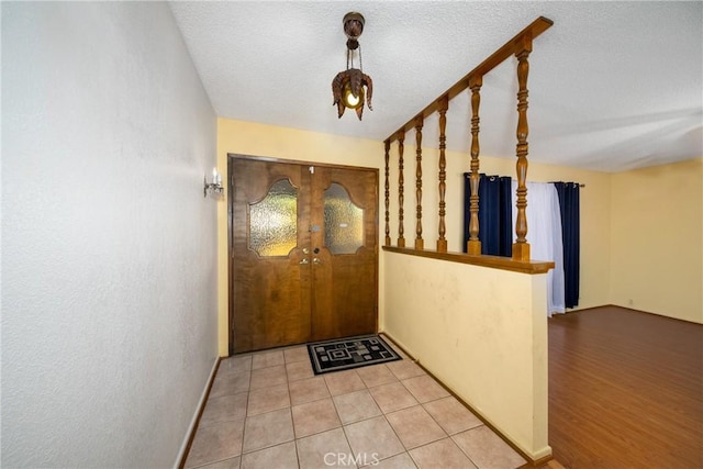 entryway with wood-type flooring and a textured ceiling