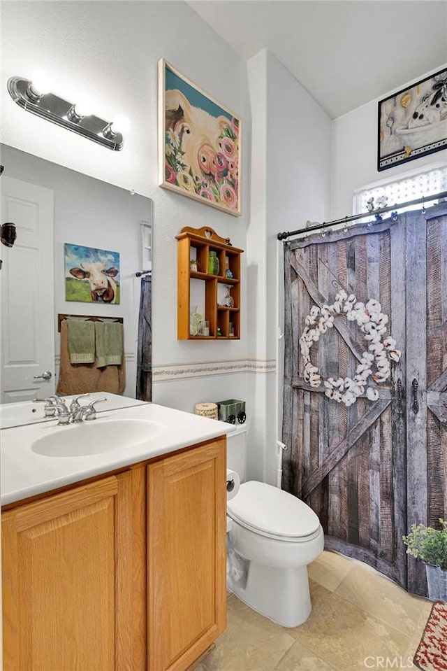 bathroom with vanity, a shower with shower curtain, tile patterned floors, and toilet