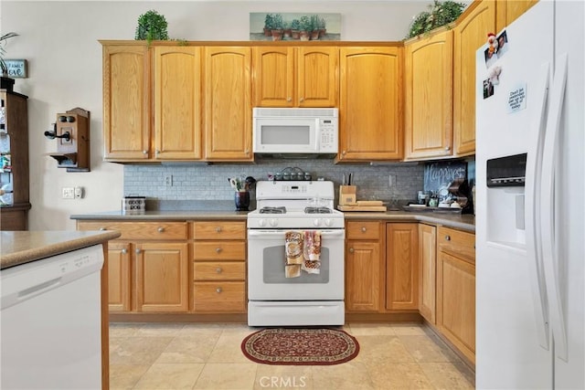 kitchen with white appliances, decorative backsplash, and light tile patterned flooring