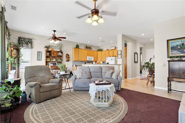 living room featuring ceiling fan and light tile patterned flooring