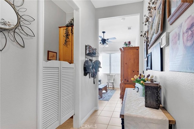 hall featuring light tile patterned flooring