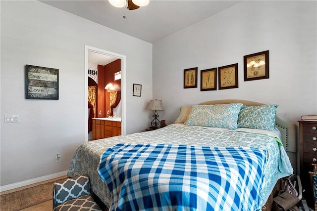 bedroom with ensuite bath and ceiling fan