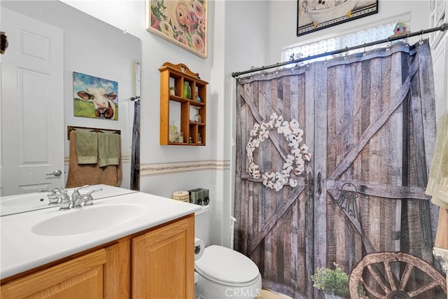 bathroom featuring vanity, toilet, and a shower with shower curtain