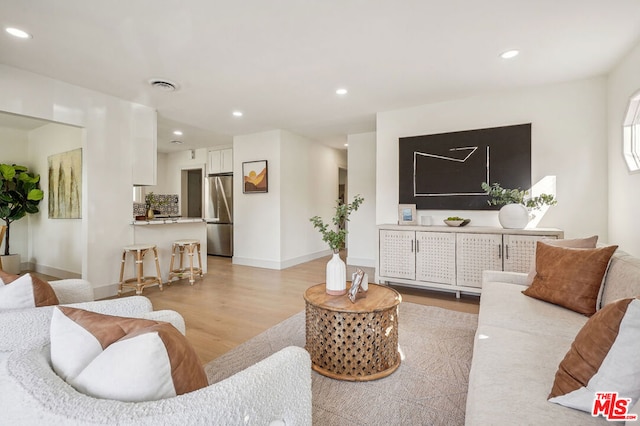 living room with light hardwood / wood-style flooring