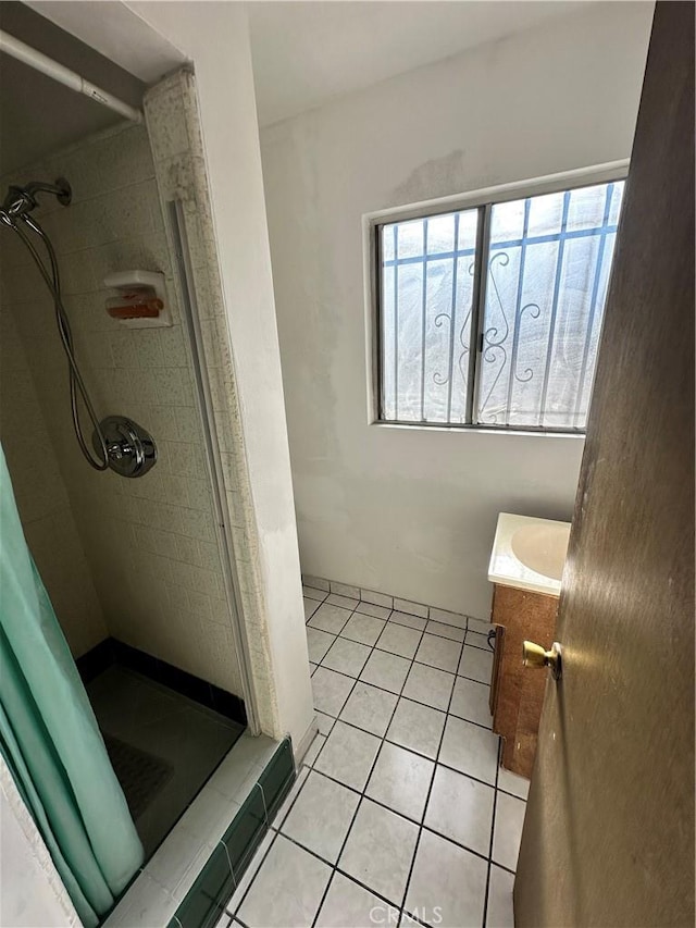 bathroom featuring tile patterned floors, vanity, and walk in shower