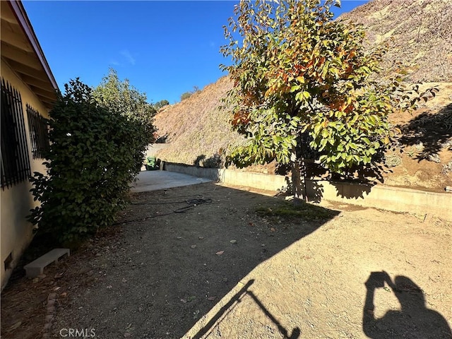 view of yard featuring a mountain view and a patio