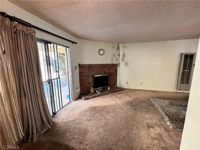 unfurnished living room featuring a fireplace, a textured ceiling, and carpet floors