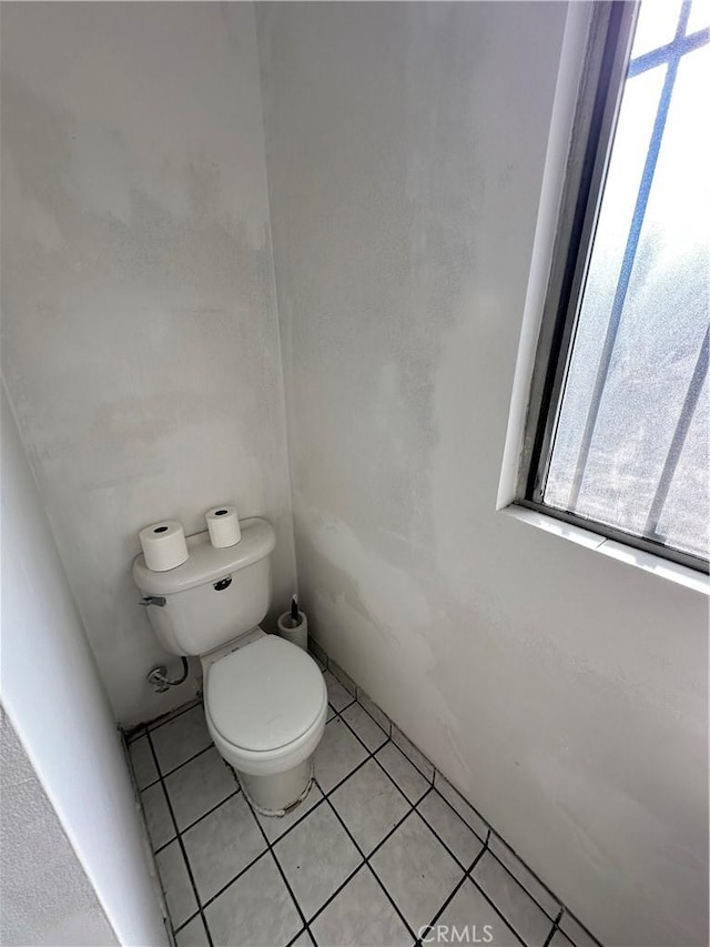 bathroom with tile patterned floors and toilet