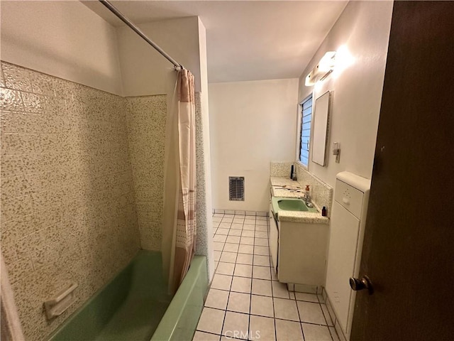 bathroom with tile patterned flooring, vanity, and shower / tub combo