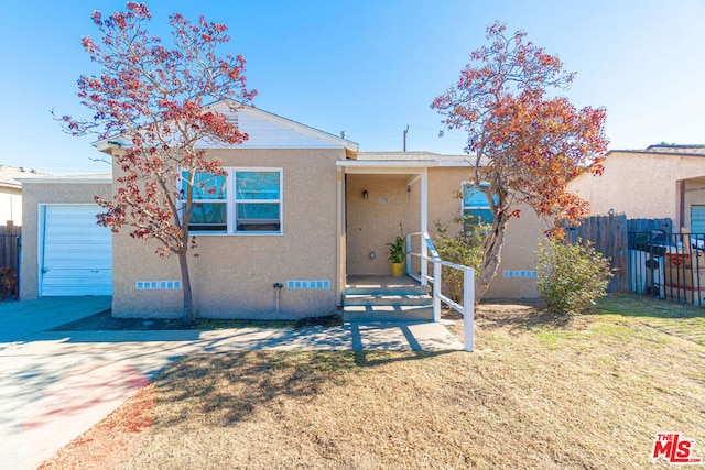 view of front facade featuring a garage and a front lawn