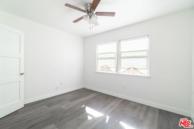 unfurnished room featuring ceiling fan and dark hardwood / wood-style flooring