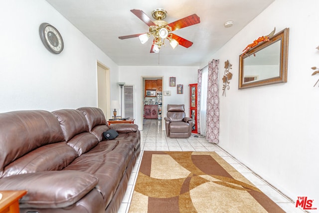 living room with ceiling fan and light tile patterned floors