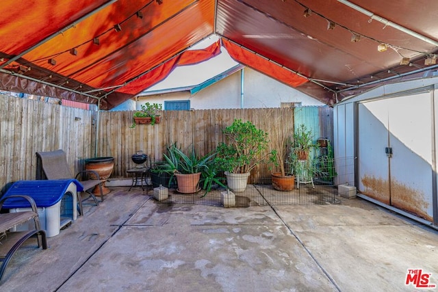 view of patio / terrace featuring a storage shed