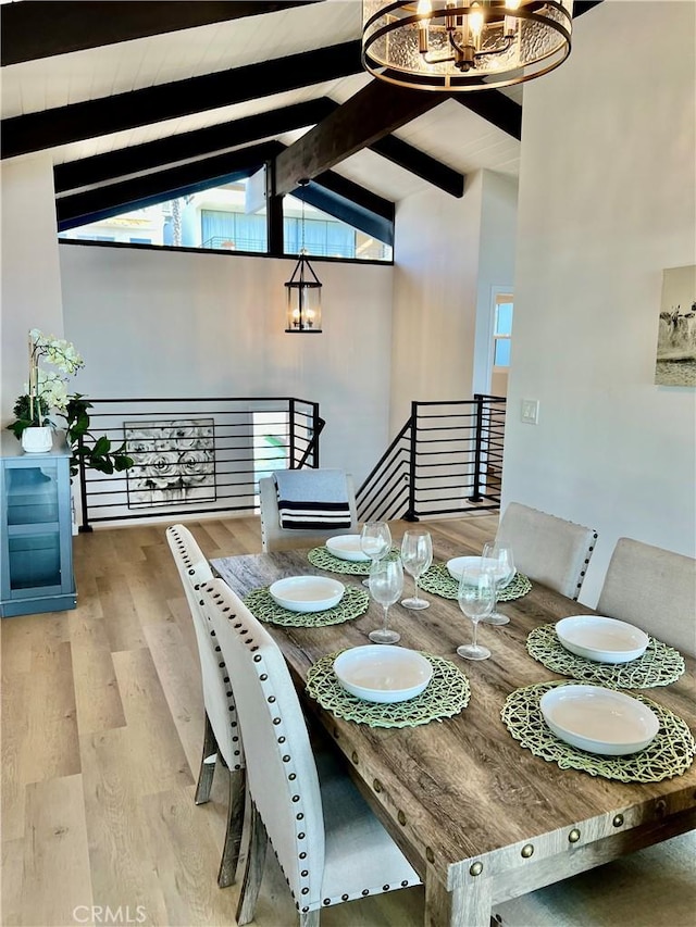 dining area with beam ceiling, an inviting chandelier, high vaulted ceiling, and hardwood / wood-style flooring