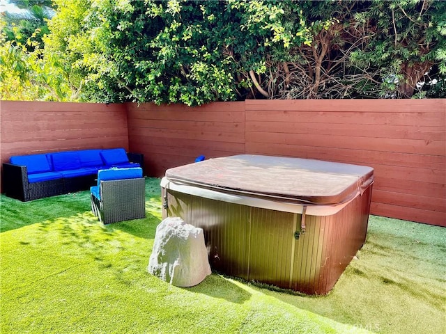 view of yard featuring outdoor lounge area and a hot tub