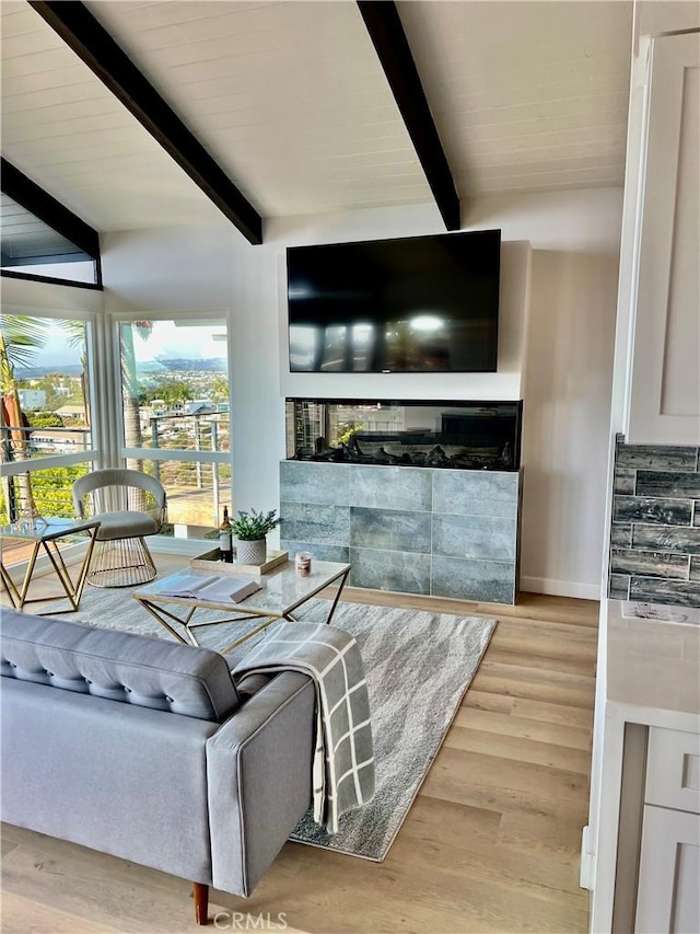 living room featuring hardwood / wood-style floors and lofted ceiling with beams