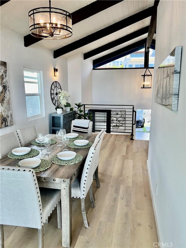 dining space with wooden ceiling, light hardwood / wood-style flooring, lofted ceiling with beams, and an inviting chandelier