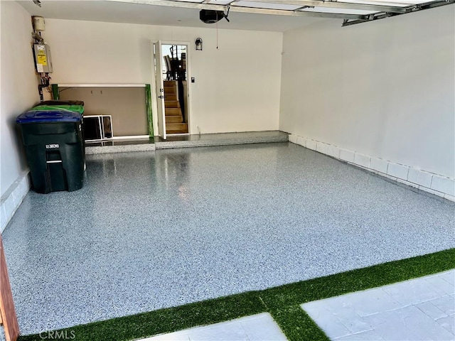 garage featuring water heater and a garage door opener