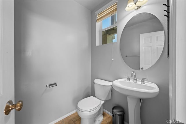 bathroom featuring toilet and tile patterned flooring