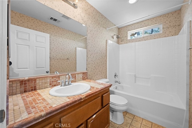 full bathroom featuring tile patterned floors, vanity, backsplash, toilet, and bathtub / shower combination