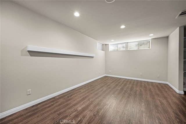 basement with dark hardwood / wood-style flooring