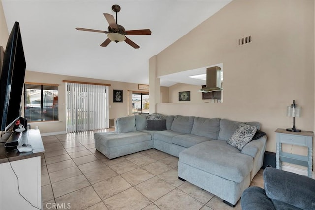 tiled living room featuring plenty of natural light, ceiling fan, and high vaulted ceiling