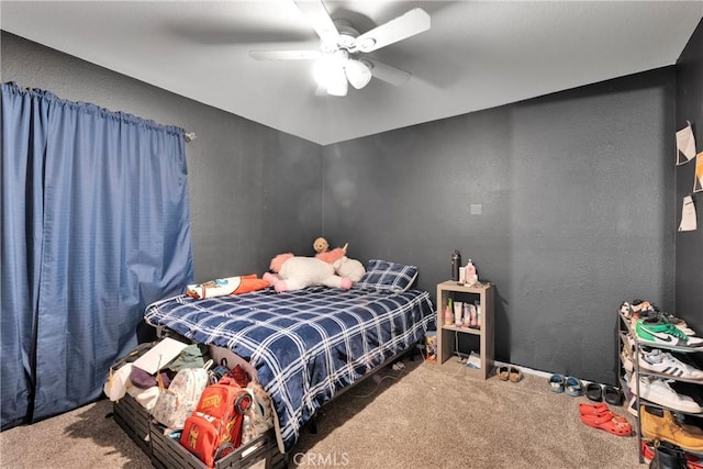 bedroom featuring ceiling fan and carpet