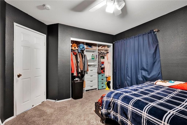 carpeted bedroom featuring a closet and ceiling fan