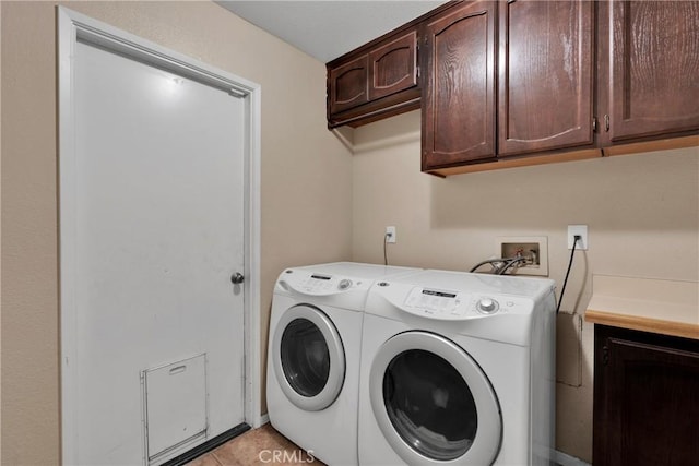 washroom featuring cabinets, separate washer and dryer, and light tile patterned floors