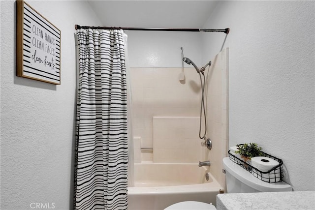 full bathroom with vanity, shower / tub combo, and toilet