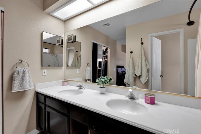 bathroom featuring a skylight and vanity