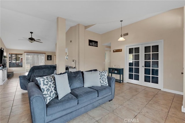 tiled living room featuring ceiling fan, high vaulted ceiling, and french doors