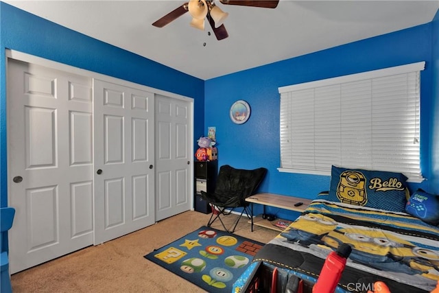 carpeted bedroom with a closet and ceiling fan