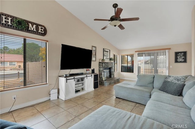 tiled living room featuring a stone fireplace, ceiling fan, high vaulted ceiling, and a healthy amount of sunlight