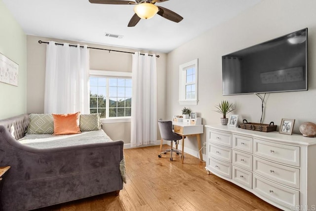 living area featuring light hardwood / wood-style flooring and ceiling fan