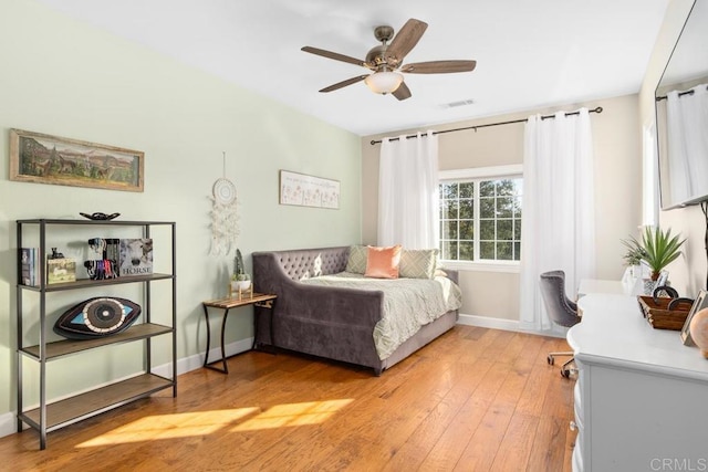 bedroom with ceiling fan and light hardwood / wood-style flooring