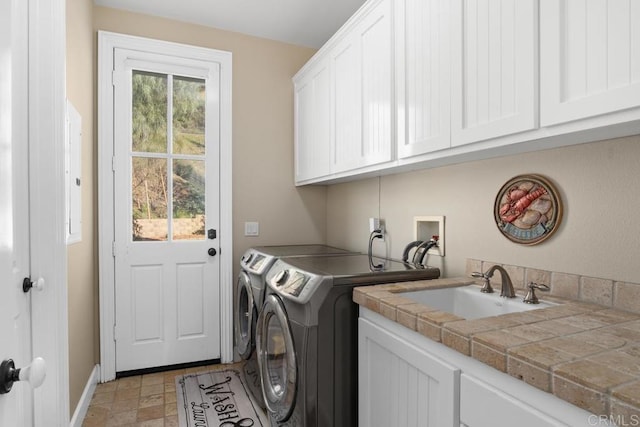 washroom with washer and dryer, plenty of natural light, cabinets, and sink