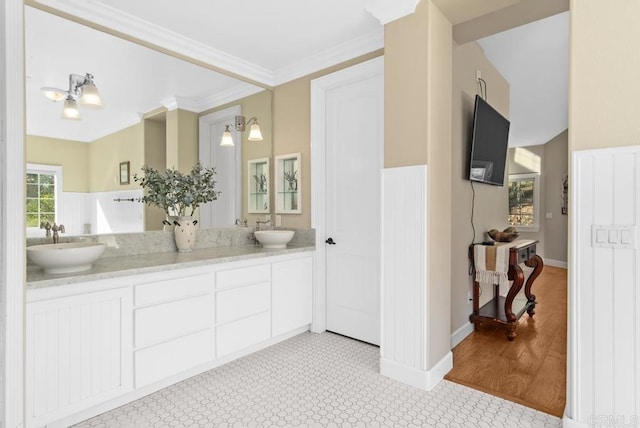 bathroom with hardwood / wood-style floors, vanity, and ornamental molding