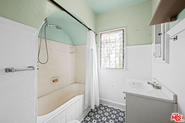 bathroom featuring shower / bath combo and vanity