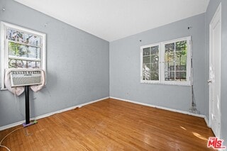 unfurnished room with hardwood / wood-style floors