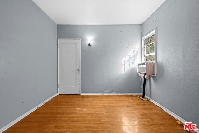 empty room with light hardwood / wood-style flooring