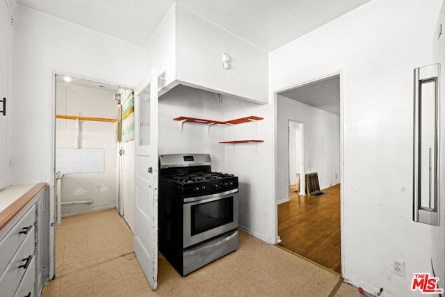 kitchen with light hardwood / wood-style floors and stainless steel gas range